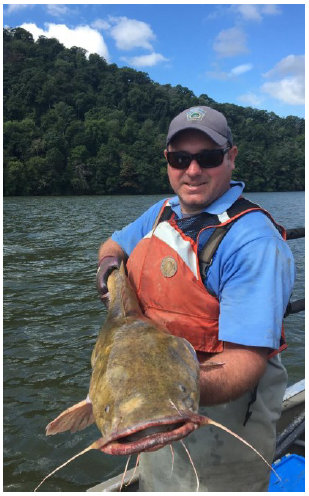 Study coauthor Geoffrey Smith, Susquehanna Riv-er biologist for the Penn-sylvania Fish and Boat Commission, with a big flathead catfish.